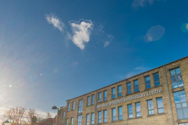 Exterior of The Elsie Whiteley Innovation Centre with bright blue skies in the background.